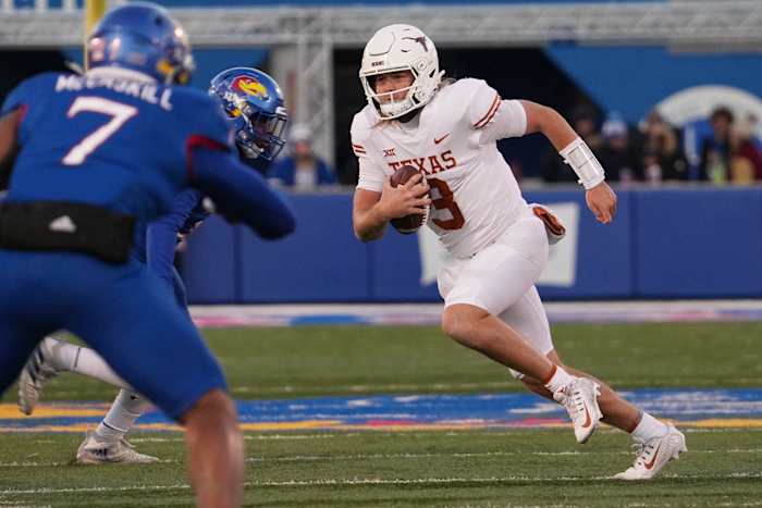 Texas Longhorns quarterback Quinn Ewers (3) carries the ball forward during the Texas Longhorns football game against the Kansas Jayhawks